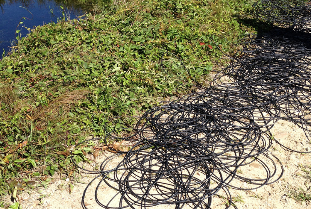 DTS fiber cable coiled next to stream channel; screenshot from 2014 summit program PDF