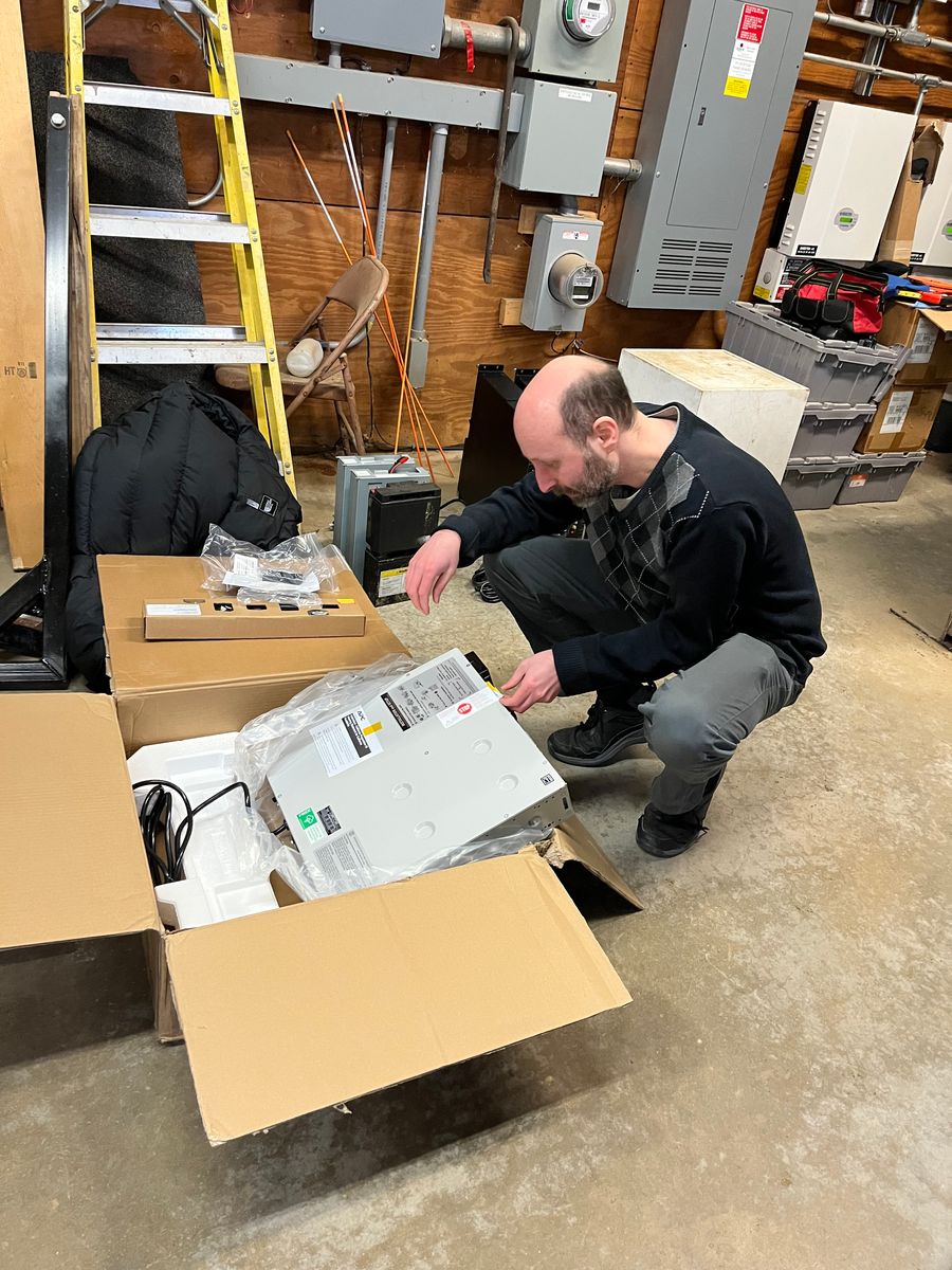 Brian unpacking the new power supply for the LO servers that run the sensor network